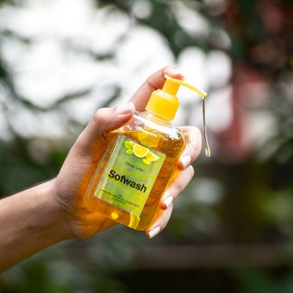 person holding yellow plastic bottle